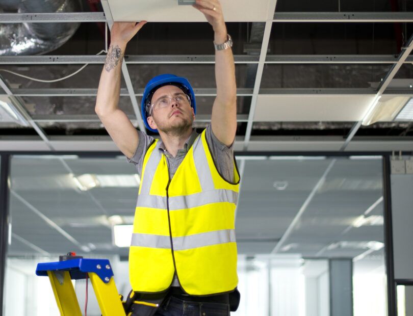 En elektriker som jobbar med elen i taket